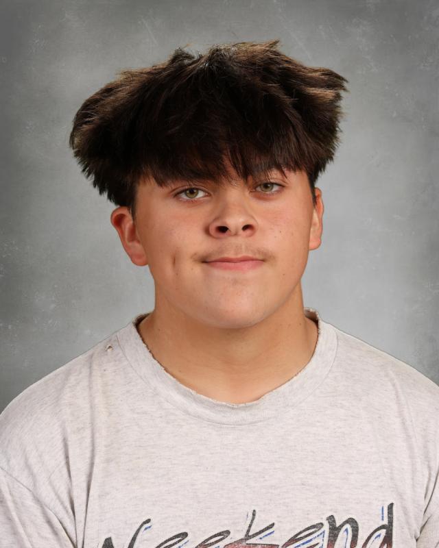 Portrait of Landon Atchison smiling in front of video production equipment